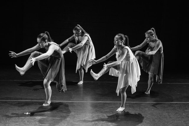 four dancers performing